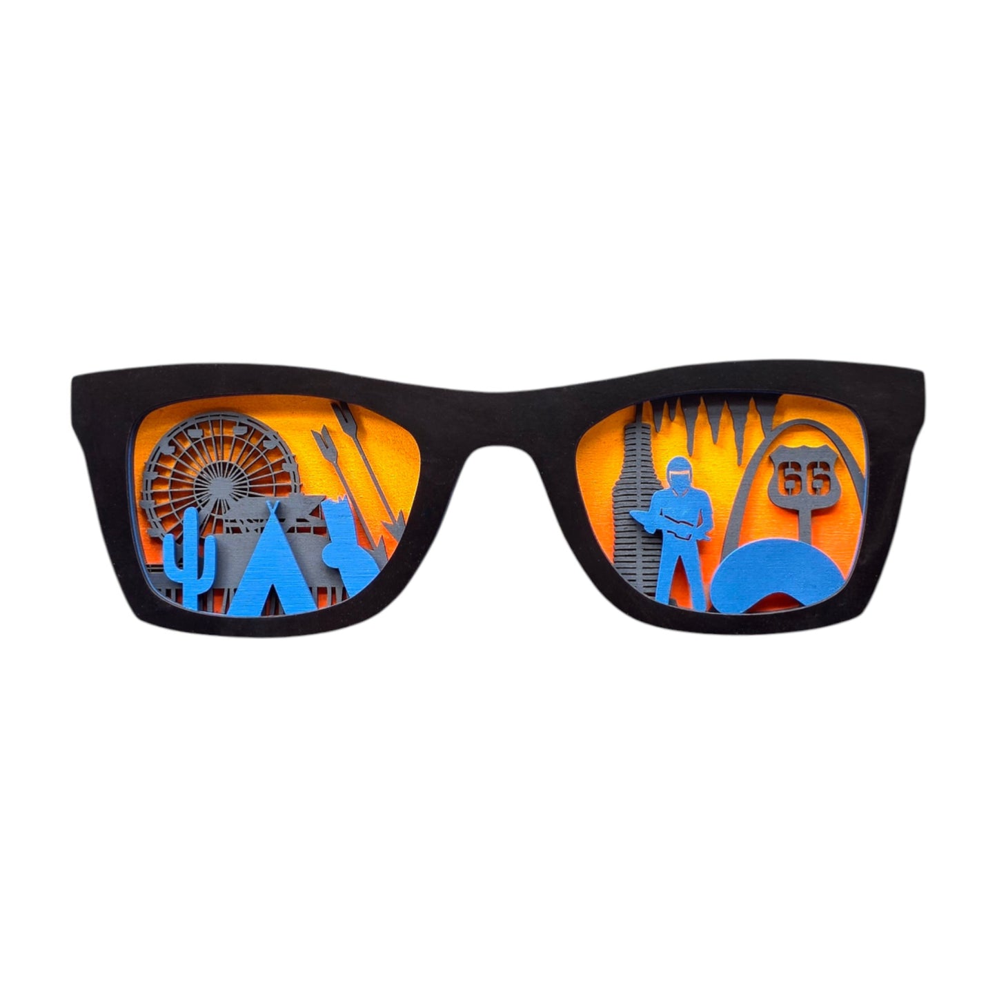 Front-facing image of black wooden Route 66 skyline glasses wall art against a plain white background, showing detailed laser-cut icons from the famous highway layered inside each lens.