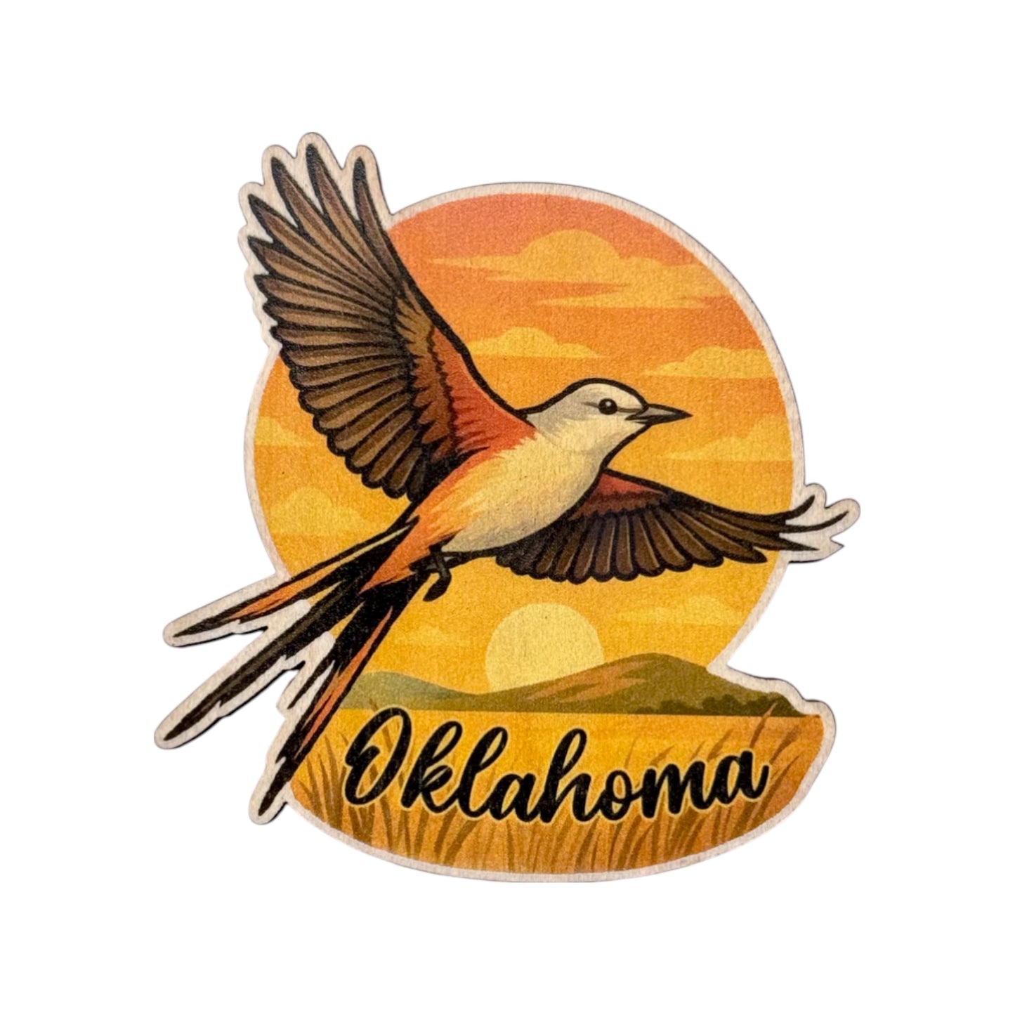 Custom cut maple wood magnet featuring a flying scissor-tailed flycatcher bird over a golden Oklahoma prairie sunset with the word Oklahoma in script