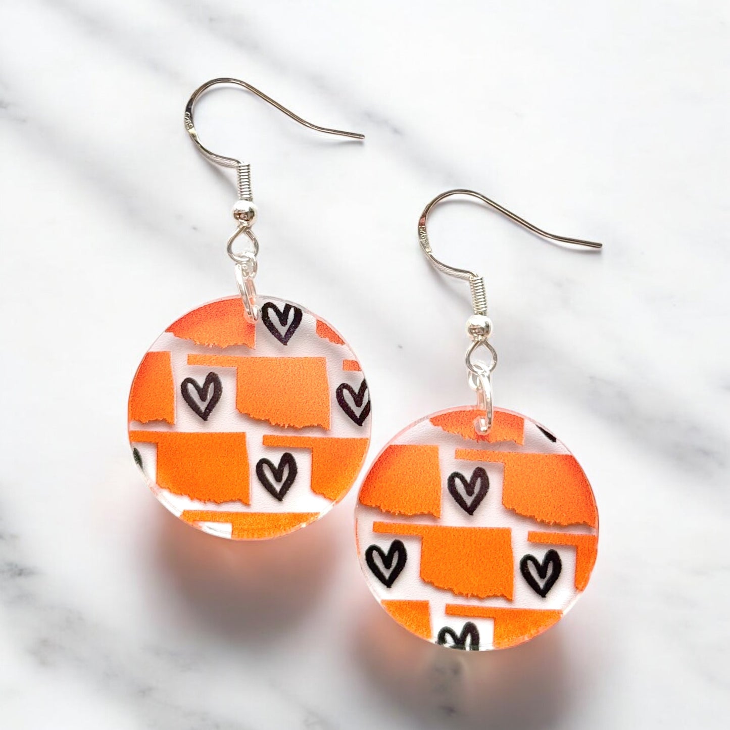 Oklahoma heart acrylic earrings with printed orange state pattern and black heart accents, lightweight hypoallergenic earrings for Oklahoma souvenir or state pride gift