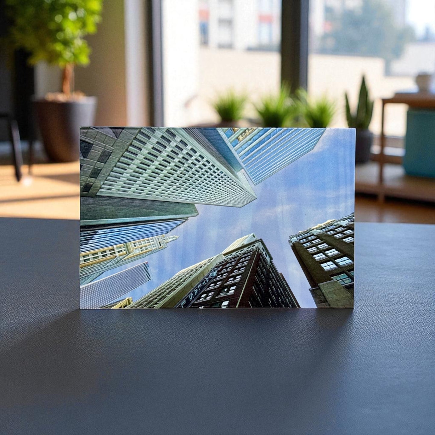 Front view of 3D textured Tulsa skyscraper photo printed on a wood block with natural sunlight and indoor plants in the background