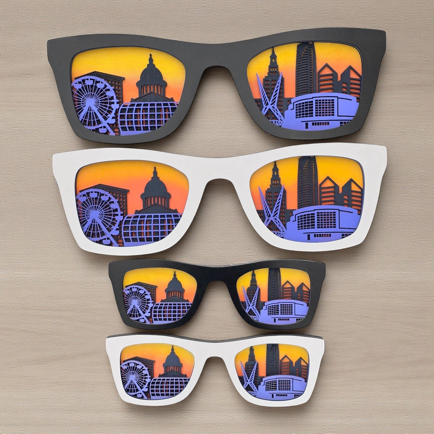 Multiple sizes of Oklahoma City skyline sunglasses wall art arranged vertically, layered city skyline decor designed for shelf display