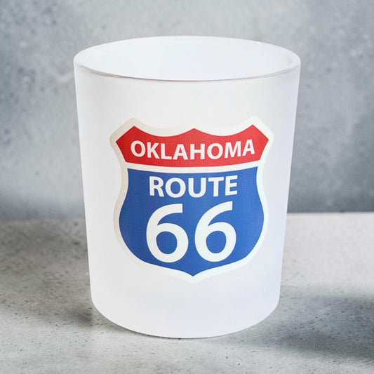 Oklahoma Route 66 frosted whiskey glass photographed against a gray studio background, showing the full-color highway shield UV printed on the front of the 8 oz lowball glass