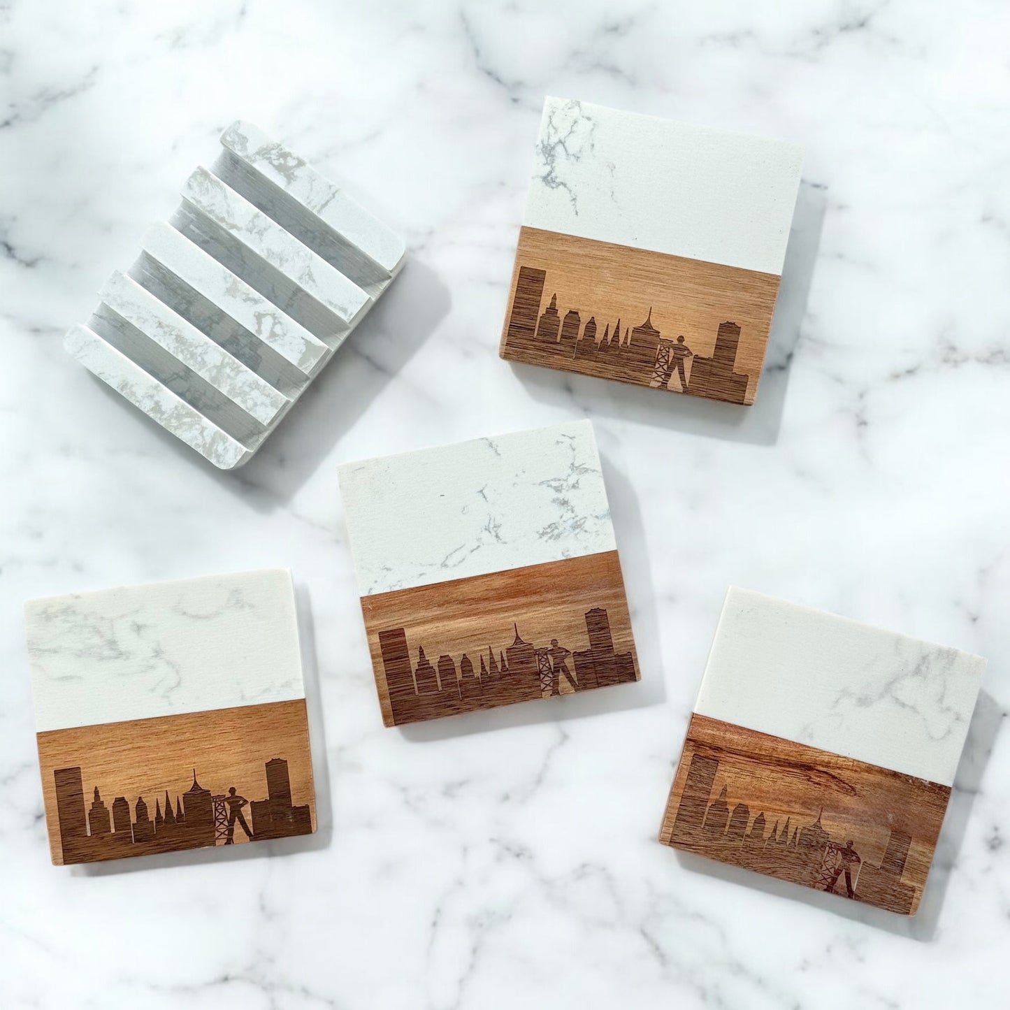 Set of four Tulsa skyline coasters with marble and acacia wood design, displayed with matching marble base on a white marble surface.