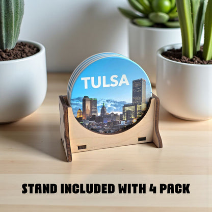 Coaster set with Tulsa skyline design on a wooden stand, surrounded by potted plants.