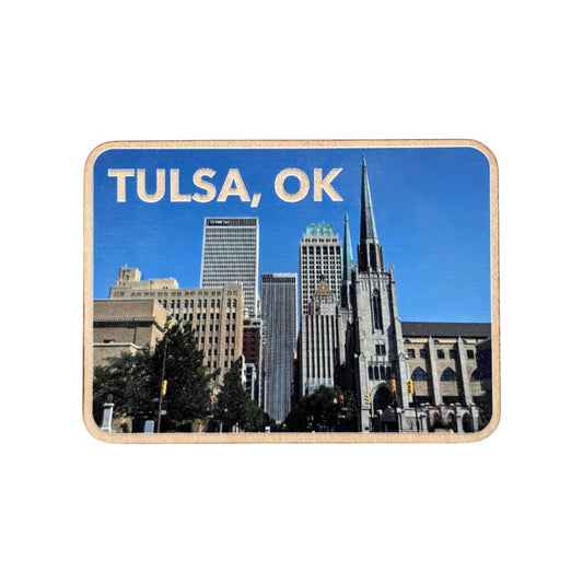 Wooden photo magnet featuring the downtown Tulsa, Oklahoma skyline with blue skies and the historic First Christian Church spire. Text at the top reads “TULSA, OK.”