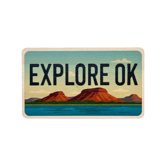 Explore Oklahoma maple wood fridge magnet featuring red mesas and blue lake in a license plate style with bold black lettering on a soft natural wood background