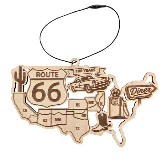 Alt text: Route 66 centennial wooden ornament shaped like the United States map with engraved Route 66 shield, vintage car, gas pump, cactus and diner sign, road trip souvenir ornament displayed on white background