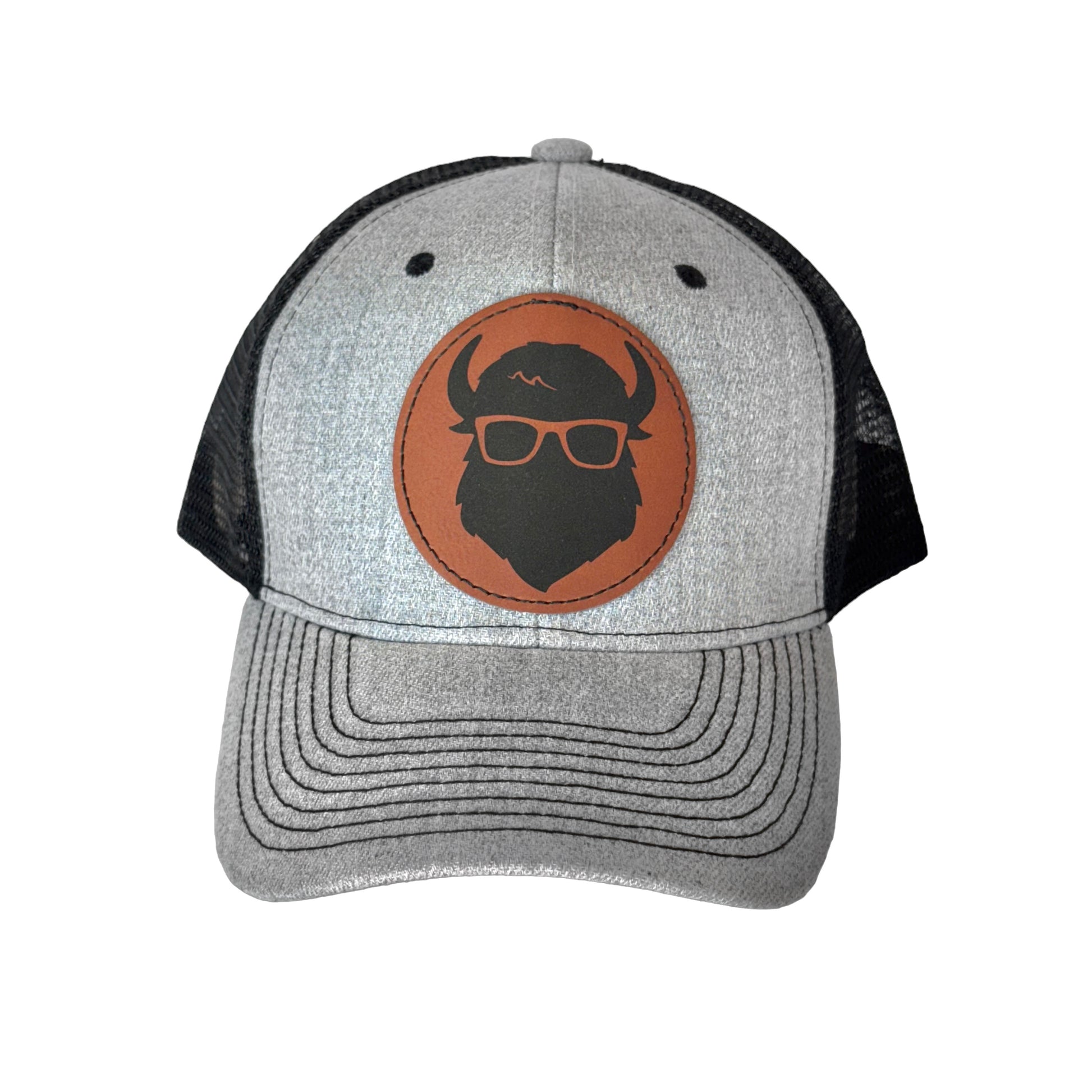 A gray snapback hat featuring The Curious Bison logo on a brown leather patch.