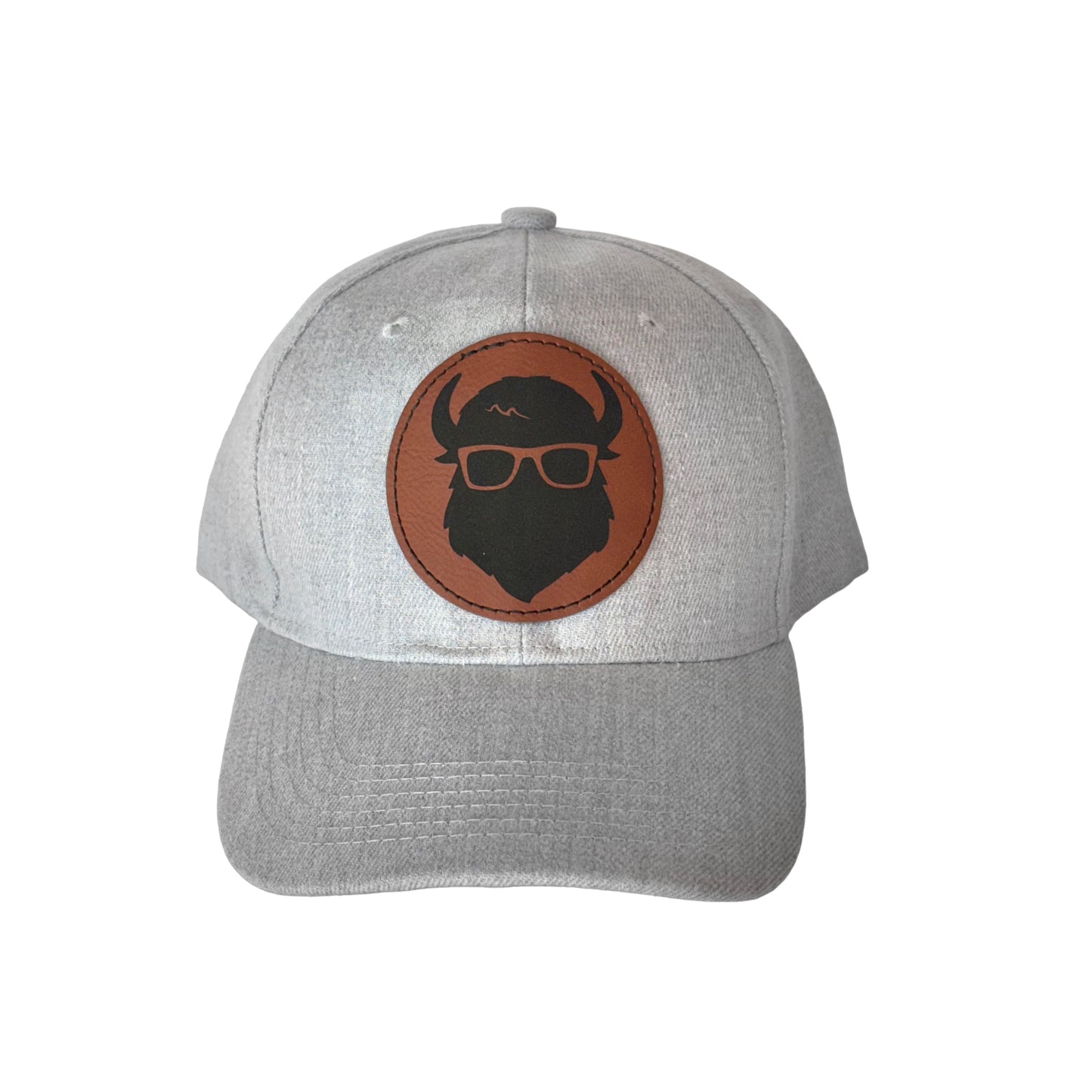 A gray velcro-back hat showcasing The Curious Bison logo on a leather patch.