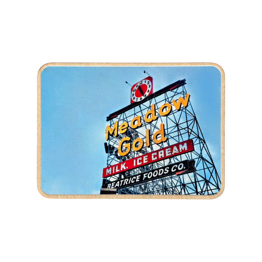 Wood photo magnet featuring the iconic Meadow Gold sign in Tulsa, Oklahoma, with bold yellow neon letters and a retro red clock, set against a bright blue sky. Image isolated on a white background.