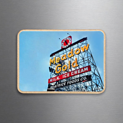 Meadow Gold sign photo magnet displayed on a metallic surface. The wooden magnet showcases the vintage Route 66 sign in Tulsa, with “Milk, Ice Cream” and “Beatrice Foods Co.” beneath the neon lettering.