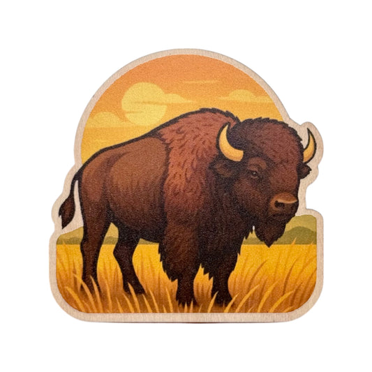 Custom cut maple wood fridge magnet featuring a bison standing in tall prairie grass with a glowing sunset and warm golden tones