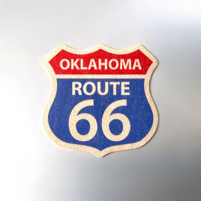Colorful Oklahoma Route 66 wood sticker photographed on a smooth silver background, ideal for indoor surfaces like laptops and notebooks