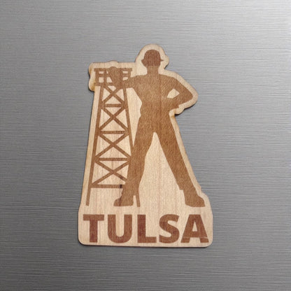 Golden Driller wood sticker featuring Tulsa’s iconic oil worker silhouette and rig, applied to a brushed metal laptop or water bottle