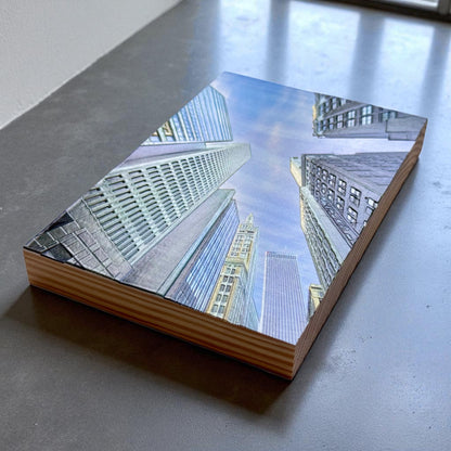 Corner perspective of wood block featuring upward skyline view of downtown Tulsa with textured architectural details on a smooth stone surface