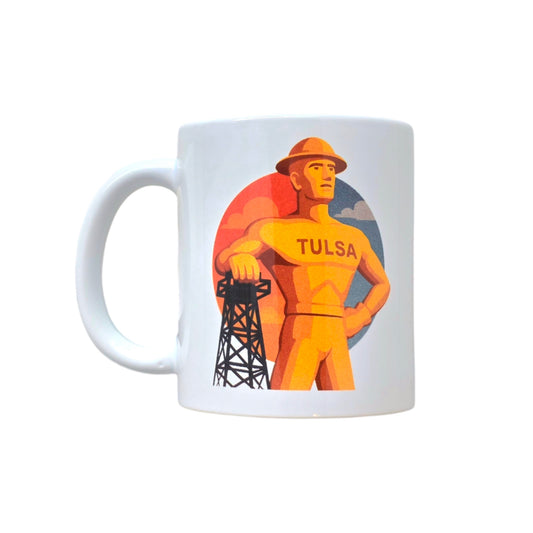 White ceramic mug featuring the Golden Driller with oil derrick and Tulsa text.