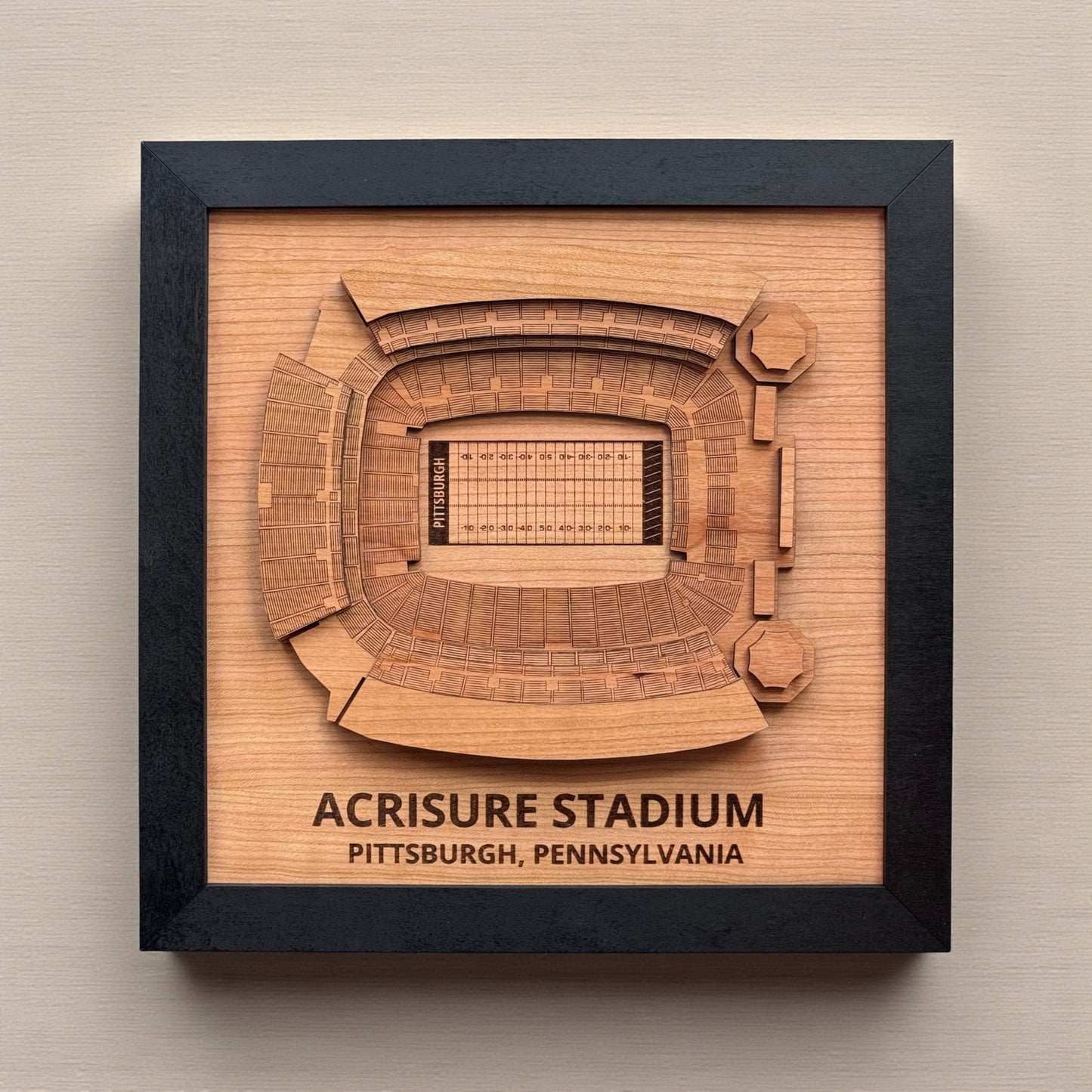 Close up of layered Acrisure Stadium wood wall art showing engraved seating sections and detailed football field markings