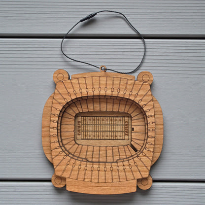 Flat lay of Arrowhead Stadium wooden ornament with engraved seating and football field layout, football stadium ornament made from wood