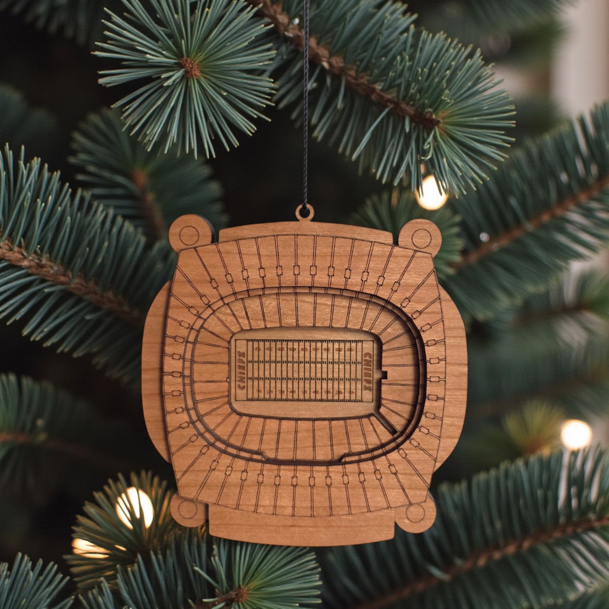 Arrowhead Stadium wooden ornament hanging on evergreen tree with lights, laser cut Kansas City football stadium ornament used as football Christmas decor