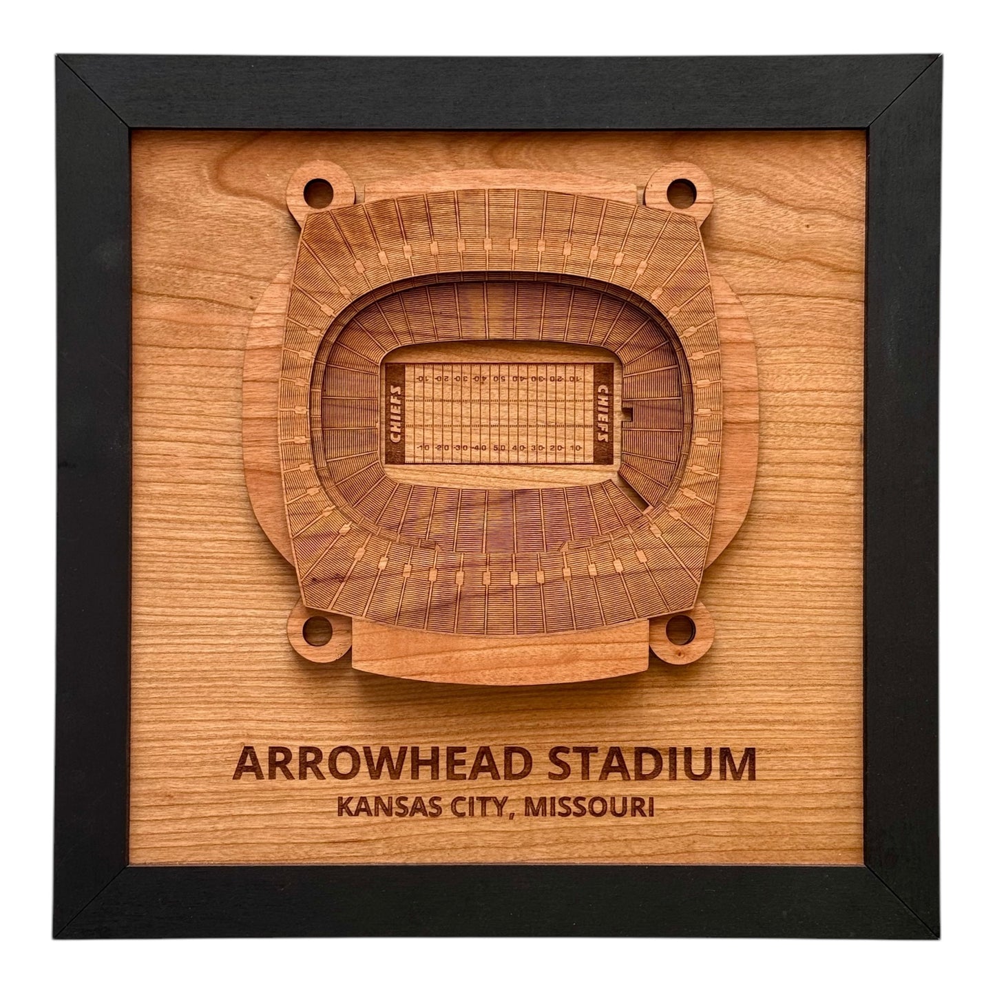 Framed wooden wall art showing a top down view of Arrowhead Stadium with engraved stadium name and city
