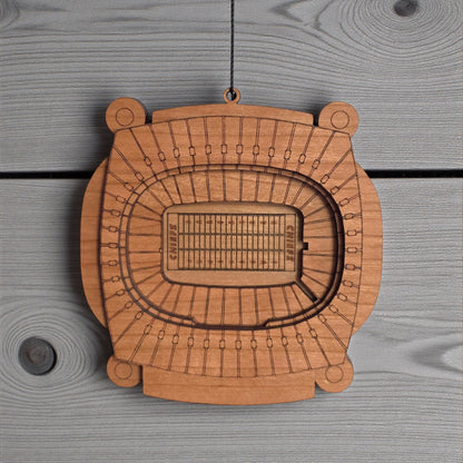 Close up of Arrowhead Stadium wooden ornament showing engraved seating sections and layered wood construction, detailed Kansas City football stadium ornament
