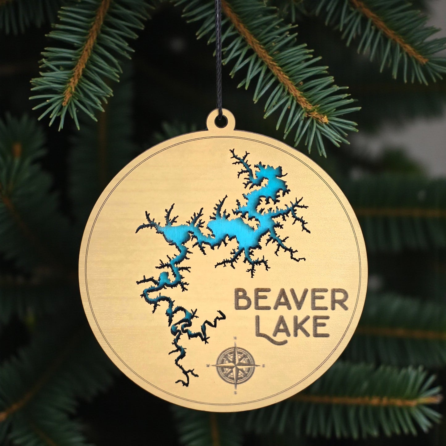 Beaver Lake wooden ornament hanging on evergreen tree, layered wood lake map ornament with blue painted water detail and hanging cord