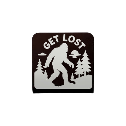 Bigfoot “Get Lost” metal hat clip with laser-cut Sasquatch design and forest background, handcrafted adventure accessory by The Curious Bison.
