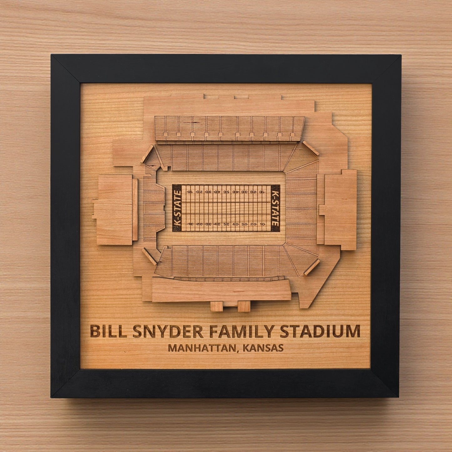 Close up of Bill Snyder Family Stadium wooden map showing engraved field details and layered seating sections, Kansas State football stadium art