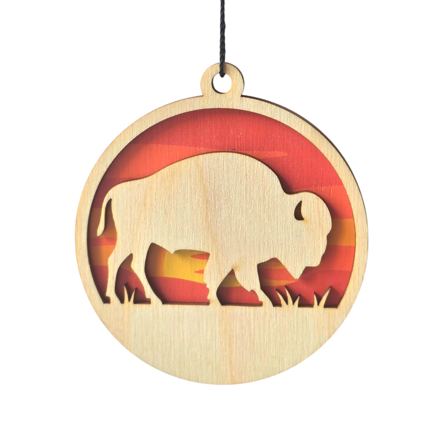 Layered bison sunset wooden ornament with natural wood cutout front and printed sunset back layer, wildlife ornament with black hanging cord