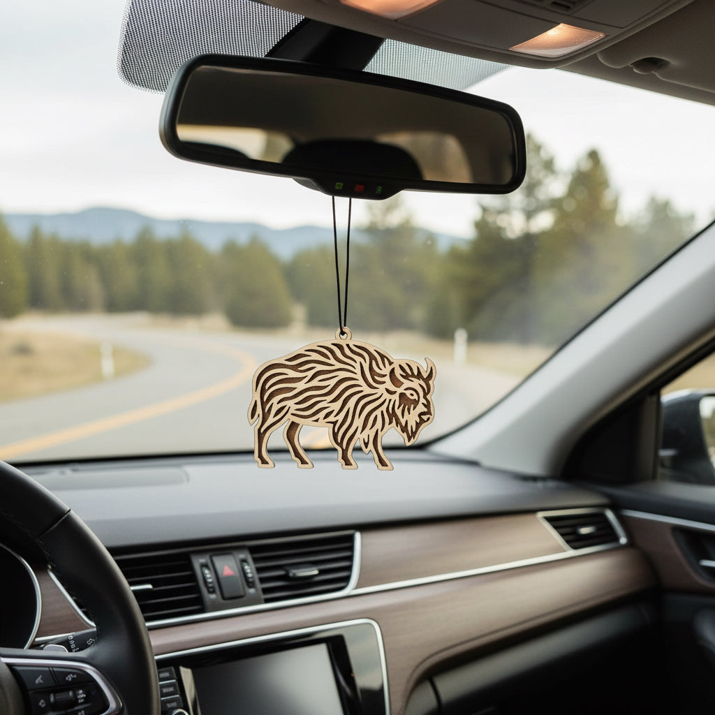 Laser cut wooden bison car ornament hanging from rearview mirror, textured buffalo silhouette design with layered wood detail and black cord, rustic auto accessory gift for Oklahoma travelers, road trip lovers, and USA wildlife fans