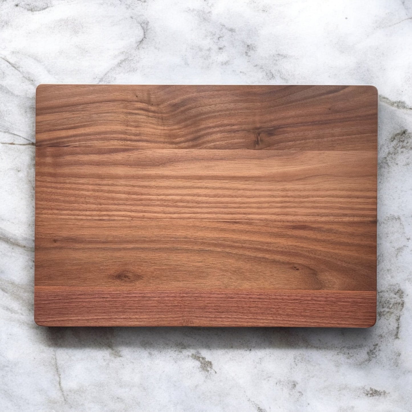 Plain walnut cutting board showing natural grain pattern and smooth food safe finish