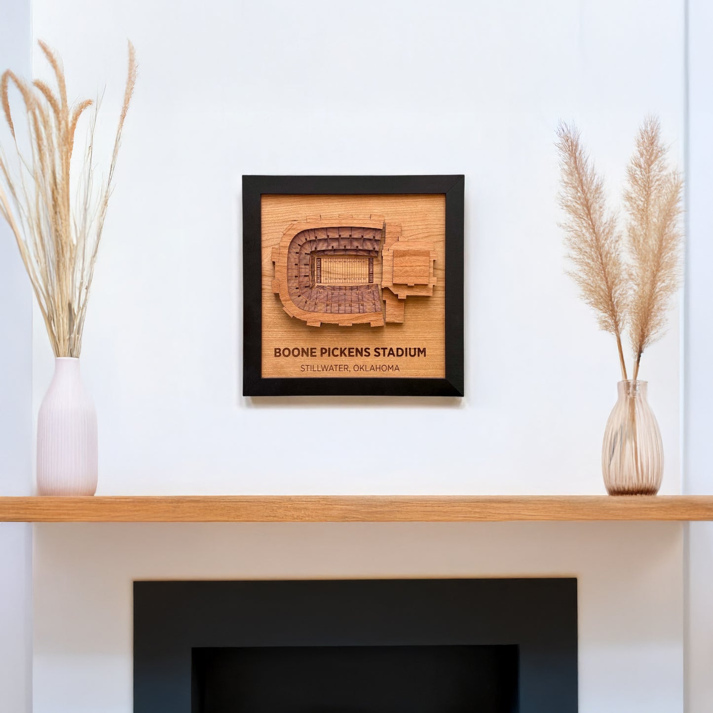Boone Pickens Stadium wooden wall art displayed on a white wall above a shelf