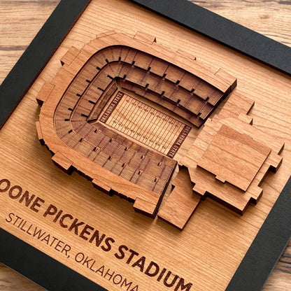 Close up of layered wooden Boone Pickens Stadium art showing engraved seating and field details