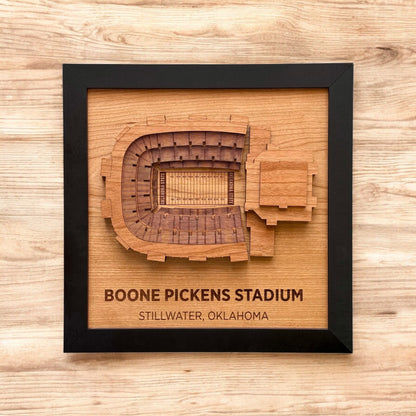 Framed wooden wall art featuring a top down view of Boone Pickens Stadium with engraved stadium name