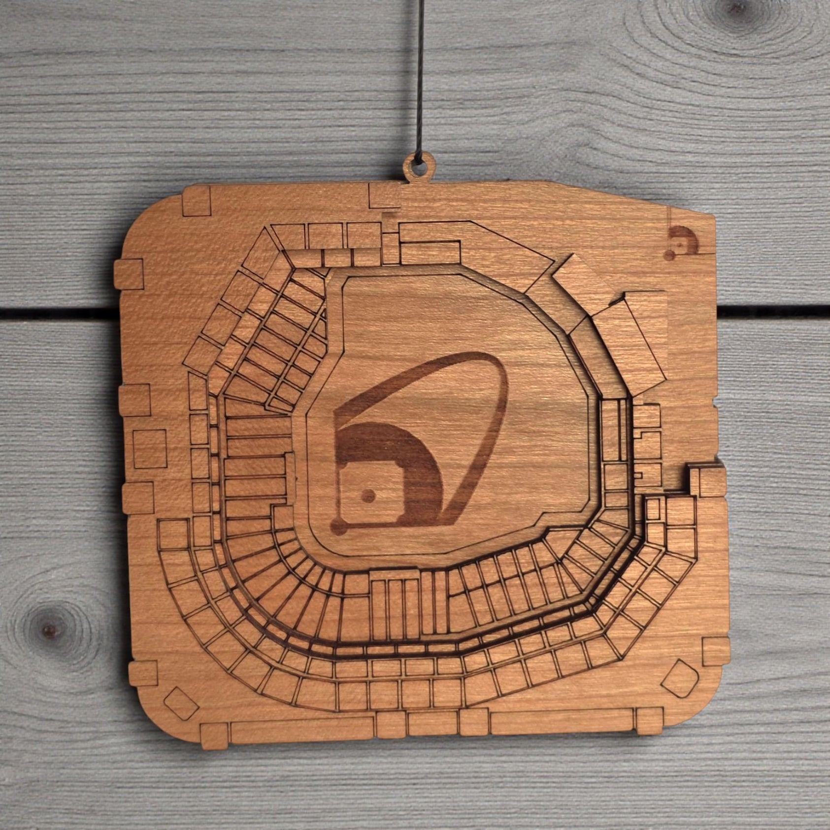 Close up of Busch Stadium wooden ornament showing engraved seating sections and layered wood construction, detailed MLB stadium ornament