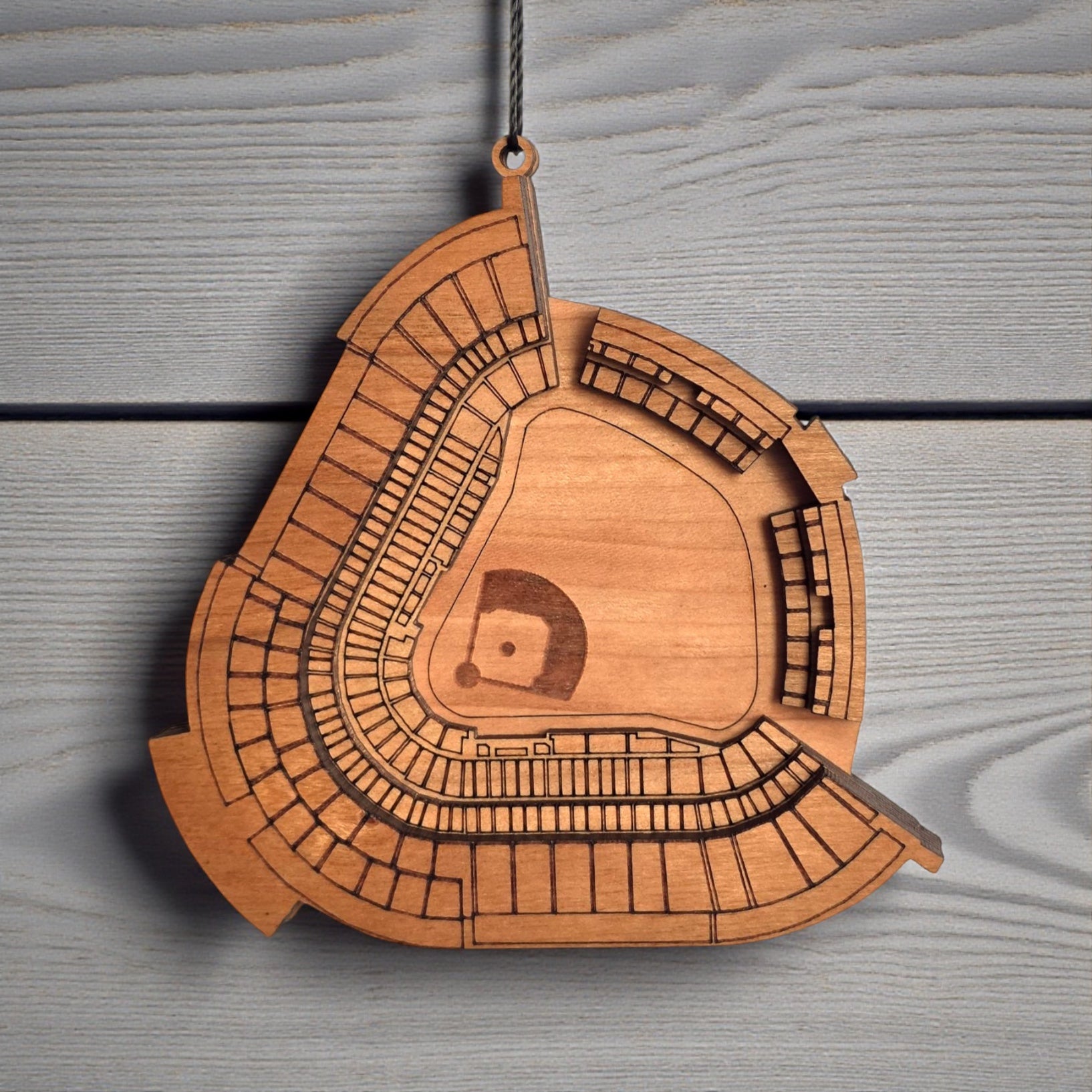 Close up of Dodger Stadium wooden ornament showing engraved seating sections and layered wood construction, detailed MLB stadium ornament