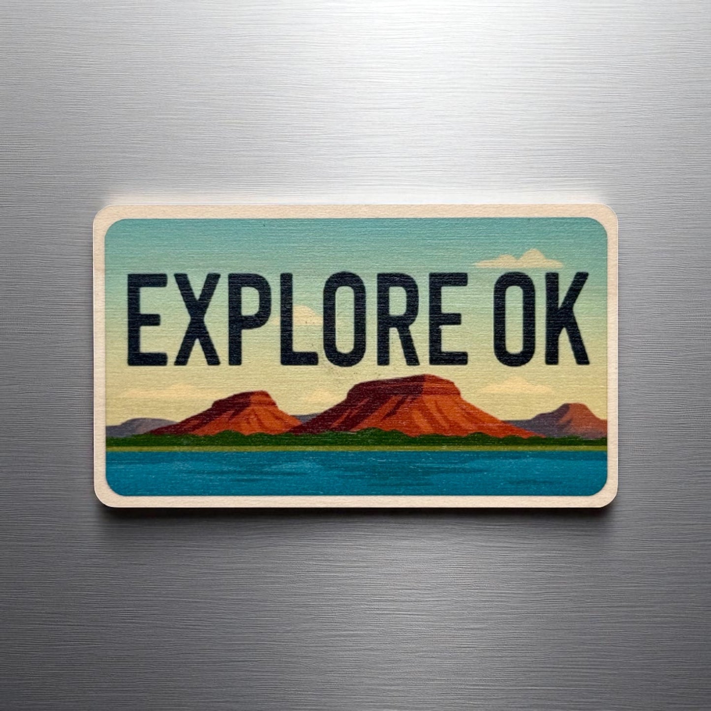 Explore Oklahoma wooden magnet displayed on a metal surface, license plate style Oklahoma magnet with scenic landscape design