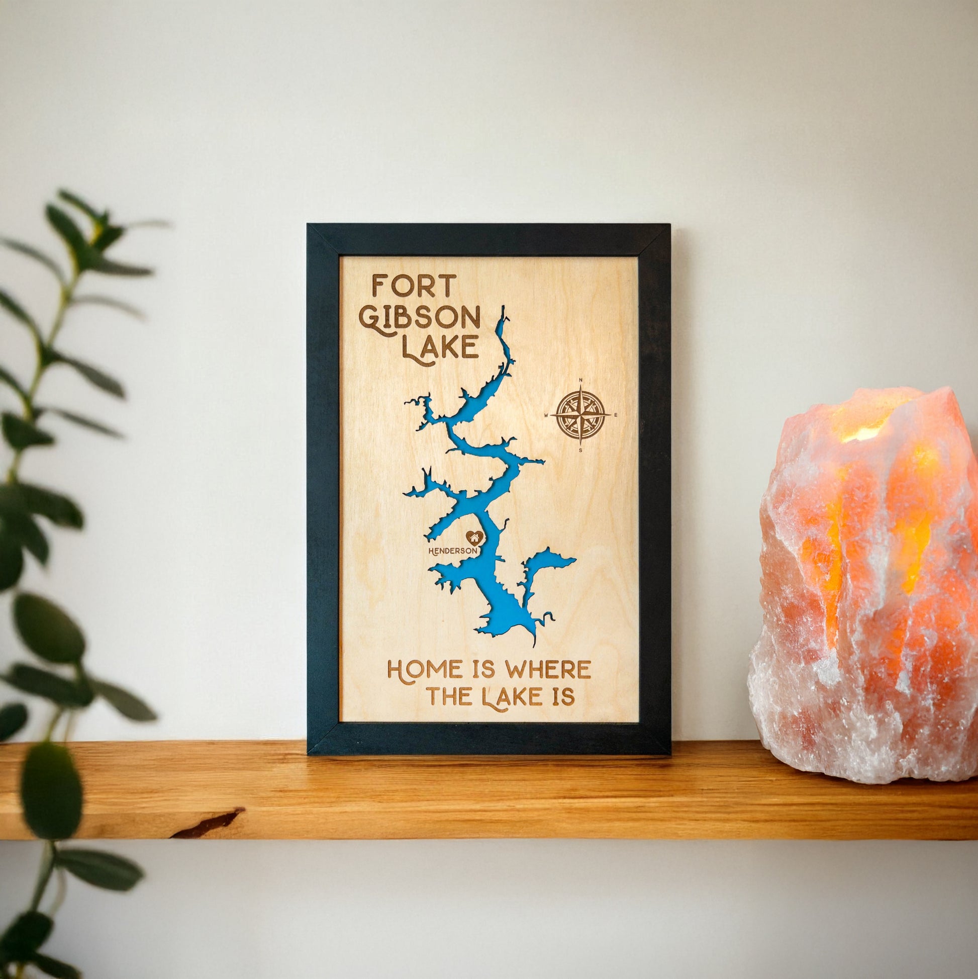 Close up of Fort Gibson Lake wood map showing blue lake backing, engraved compass rose, and shoreline detail