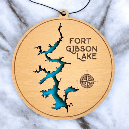 Close up of Fort Gibson Lake wooden ornament showing engraved lake name and layered blue water detail, laser cut wood lake map ornament made in the USA