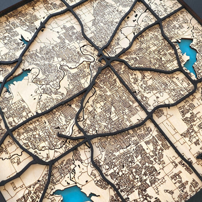 close up of Fort Worth wood map showing layered road lines and engraved street details with natural wood tones