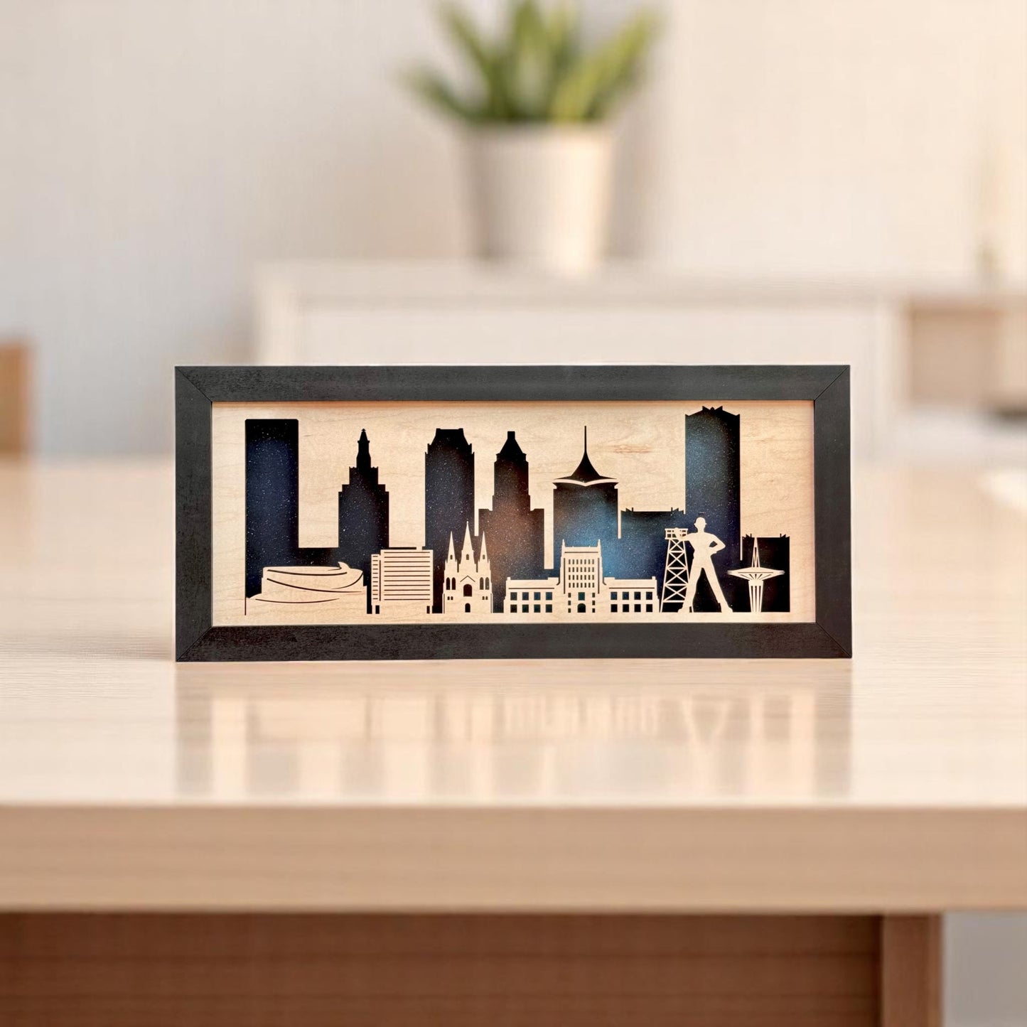 Framed wooden Tulsa skyline silhouette with night sky background displayed on a modern desk, featuring famous Oklahoma landmarks