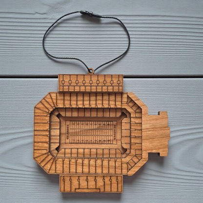 Flat lay of Gaylord Family Memorial Stadium wooden ornament with engraved seating and football field layout, college football stadium ornament made from wood