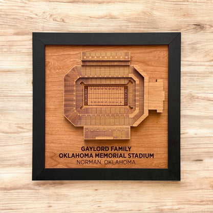 Flat lay view of framed Oklahoma Memorial Stadium wood art on a wood surface