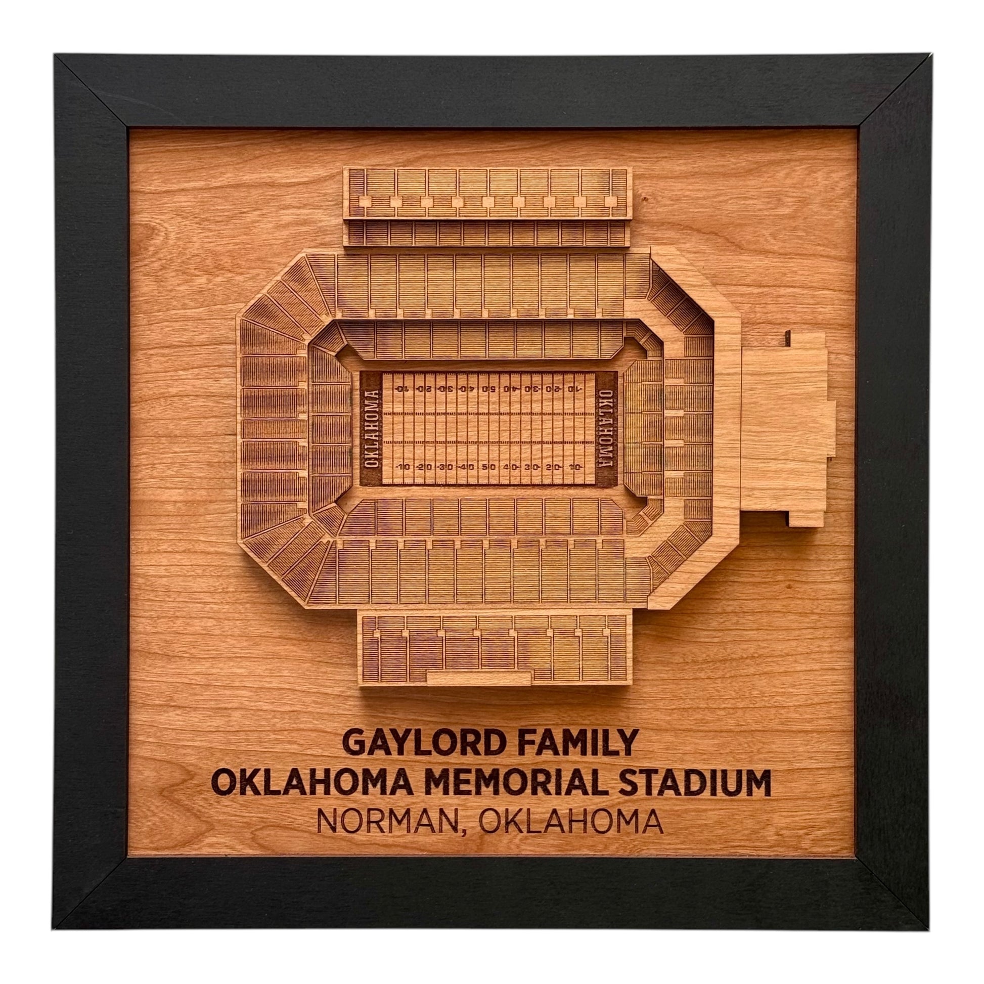 Framed wooden wall art showing a top down view of Gaylord Family Oklahoma Memorial Stadium with engraved stadium name