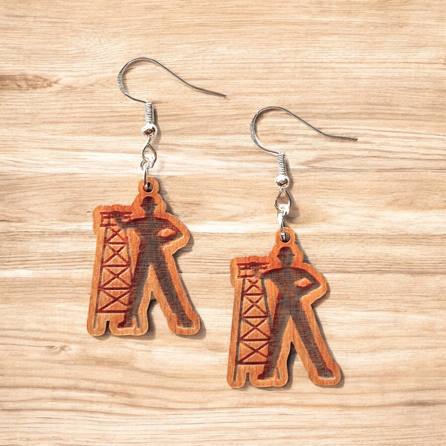 Golden Driller wooden earrings showing laser cut Tulsa landmark design with oil derrick silhouette, lightweight hypoallergenic wood earrings for Tulsa souvenir or Oklahoma gift