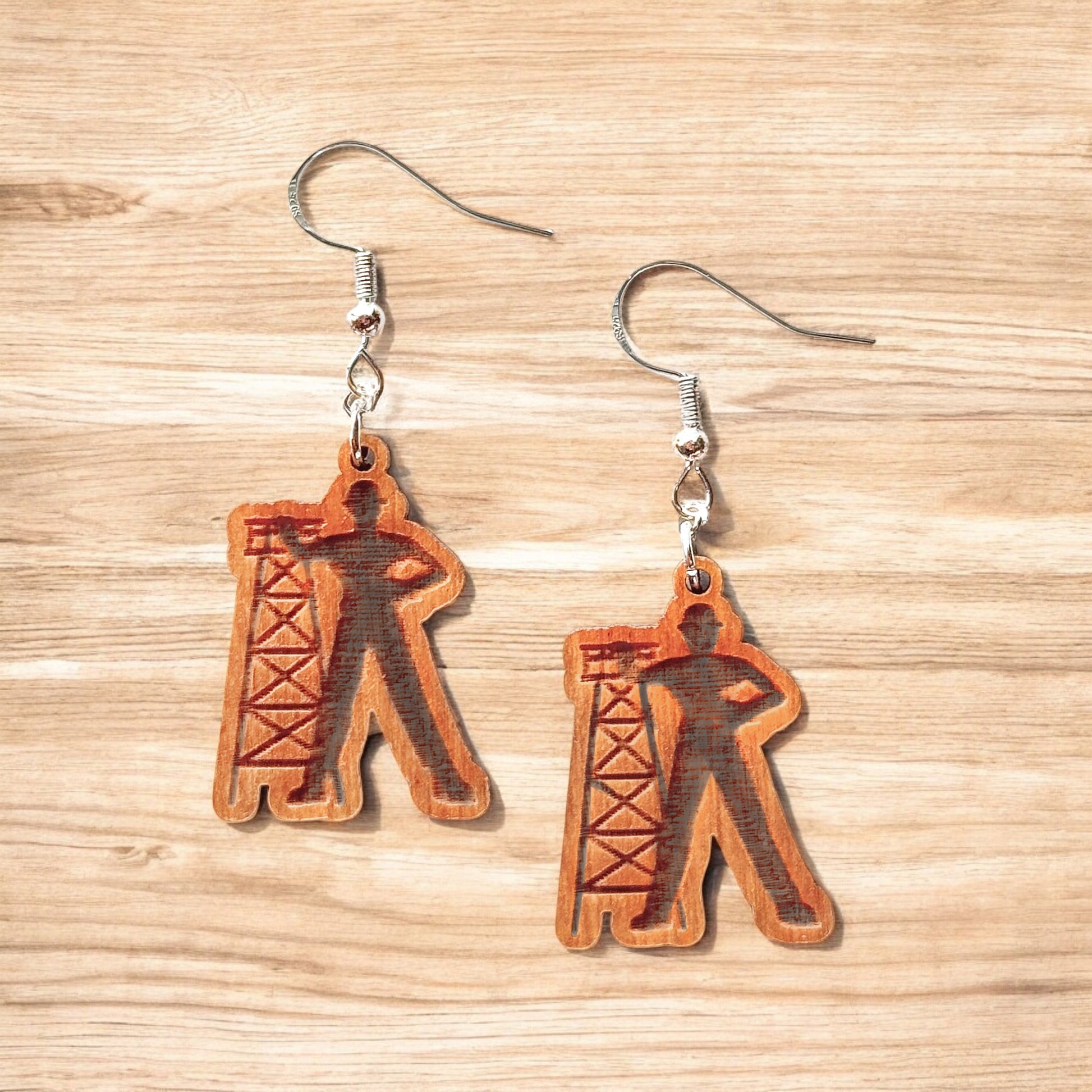 Golden Driller wooden earrings showing laser cut Tulsa landmark design with oil derrick silhouette, lightweight hypoallergenic wood earrings for Tulsa souvenir or Oklahoma gift
