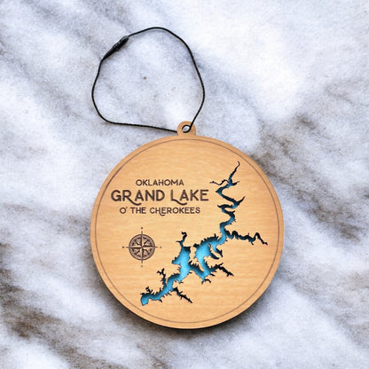Grand Lake O the Cherokees layered wooden ornament displayed on marble surface with engraved lake name and compass detail