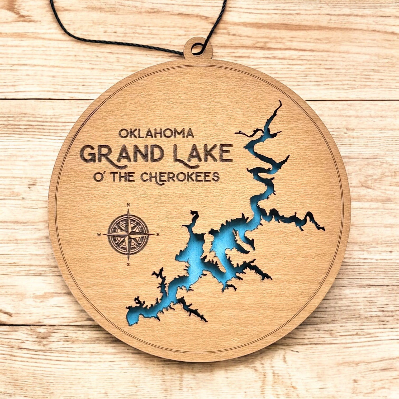 Grand Lake Oklahoma wooden ornament hanging by black cord, layered lake map ornament with painted blue water
