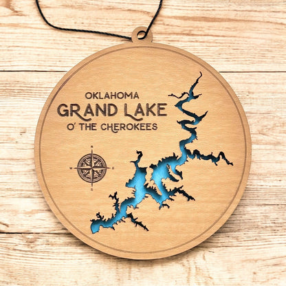 Grand Lake Oklahoma wooden ornament hanging by black cord, layered lake map ornament with painted blue water