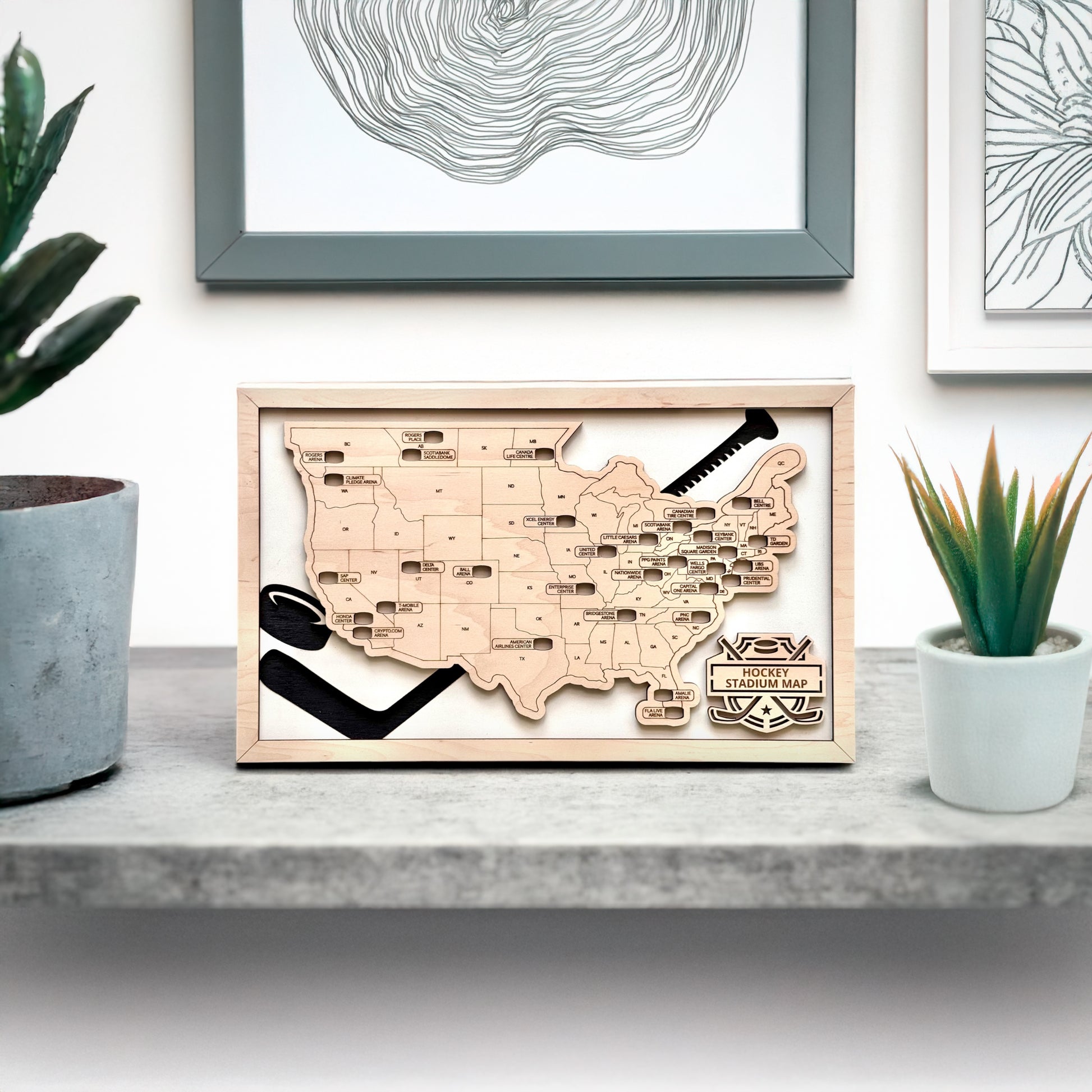 Hockey stadium map displayed on shelf with modern home decor, framed wood USA hockey arena travel tracker for hockey fans